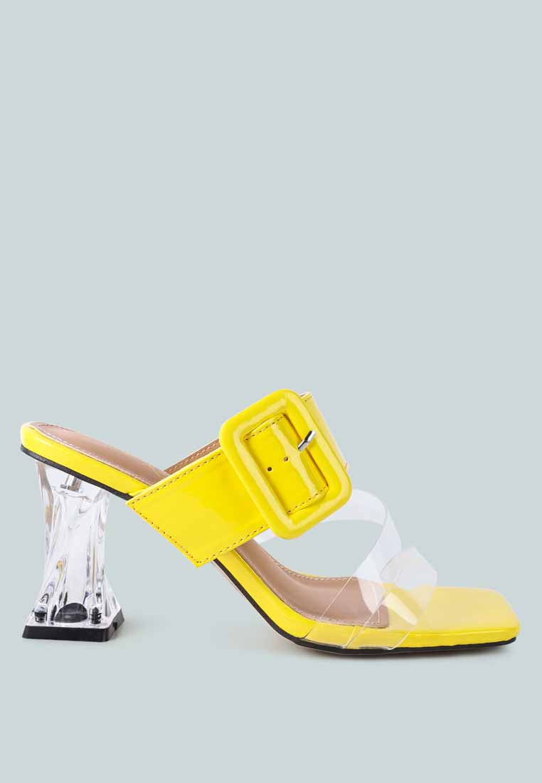 Yellow mid heel slide sandals with a clear strap. Yellow mid heel slide sandals featuring a clear strap and a unique transparent heel design.