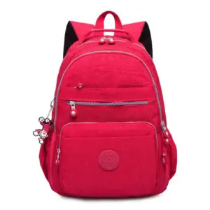 Red backpack featuring multiple compartments and a decorative keychain attached.