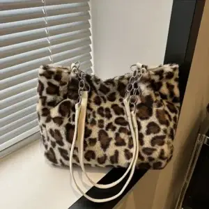 Leopard print handbag made of faux fur with white straps and silver chain details.