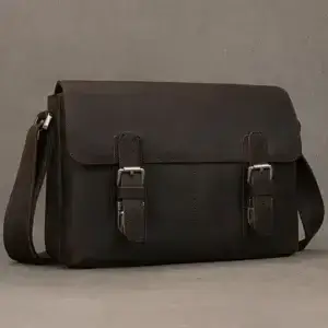Brown leather messenger bag featuring two buckle closures and an adjustable shoulder strap.