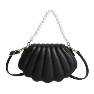 Black handbag designed in a shell shape with a pearl strap and adjustable shoulder strap.