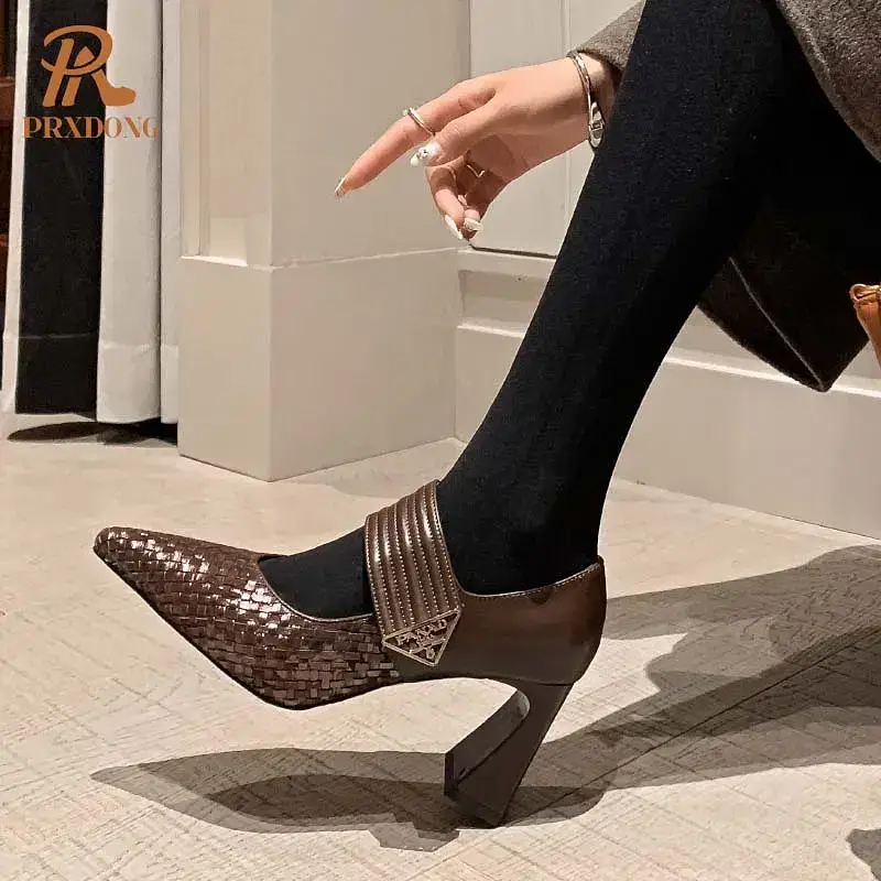 A brown high heel shoe featuring a woven design and ankle strap. Brown high heel shoe with a woven texture and a strap across the ankle.