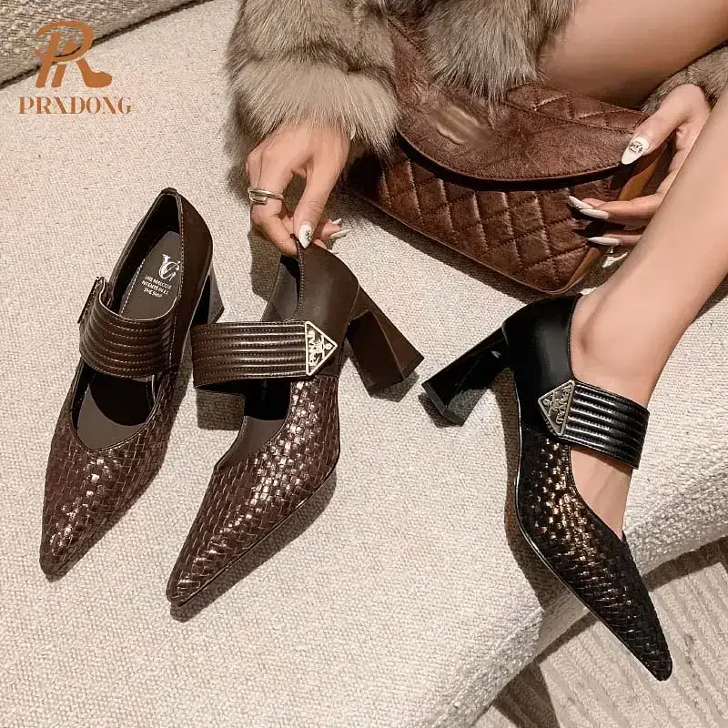 A pair of heeled shoes in brown and black with a decorative strap. Pair of brown and black heeled shoes featuring a strap and textured design.