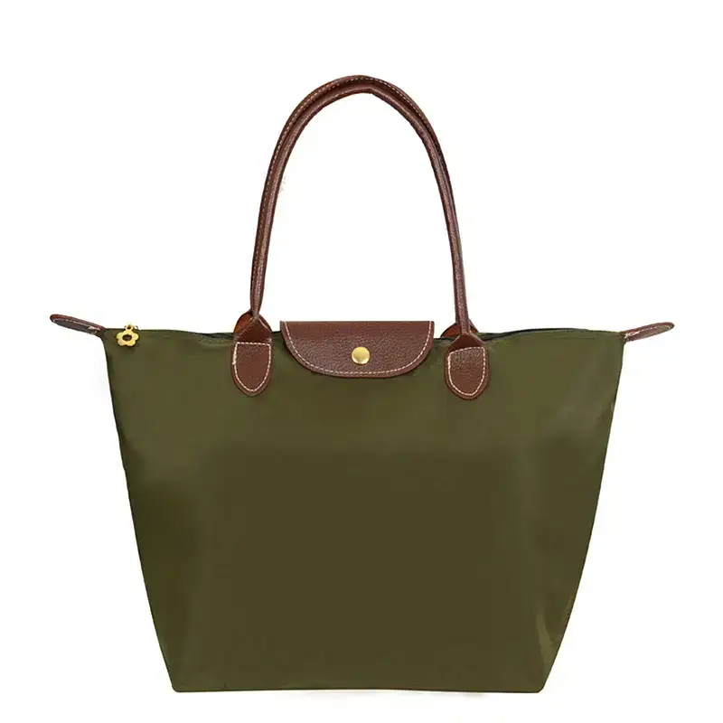 A spacious olive green tote bag with brown leather accents. Olive green tote bag with brown leather handles and a gold zipper pull.
