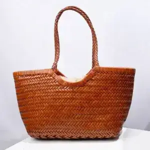 A woven brown tote bag featuring a textured design and sturdy handles. Woven brown tote bag with two handles and a spacious interior.