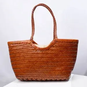 A woven brown tote bag with a textured design. Woven brown tote bag with two handles and a textured surface.