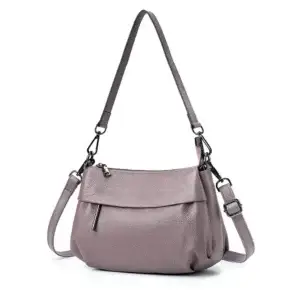 Light purple leather handbag with a single adjustable strap and zippered closure.