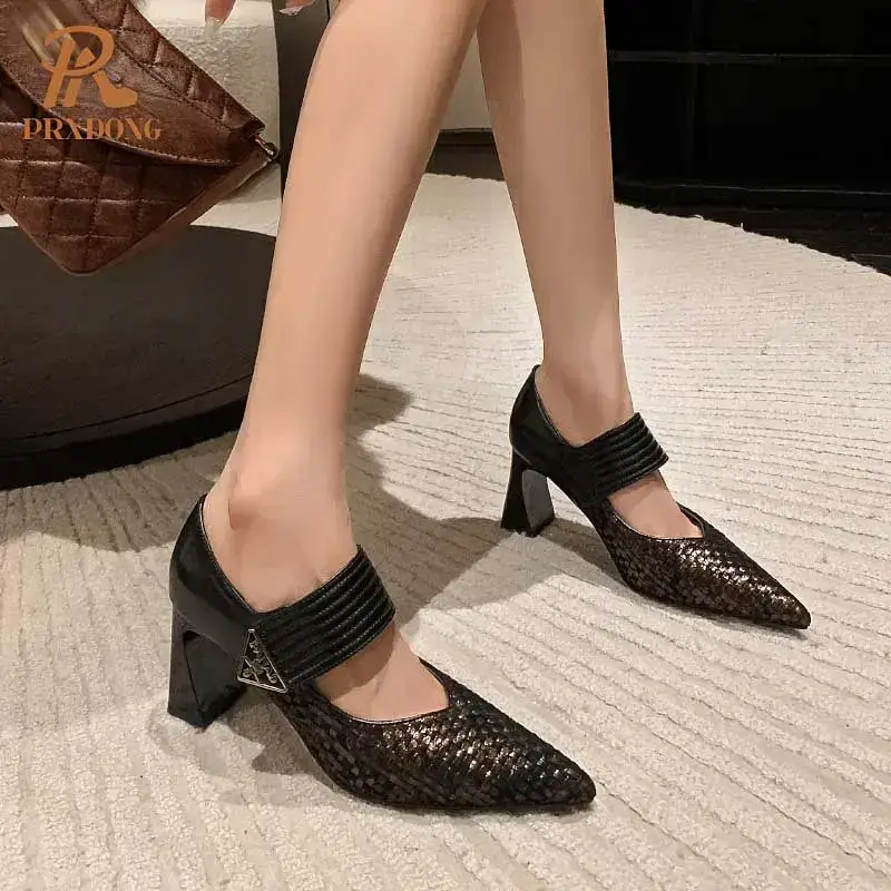 Heeled shoes with a pointed toe and ankle strap in black and brown. Black and brown heeled shoes featuring a strap across the ankle and a pointed toe design.