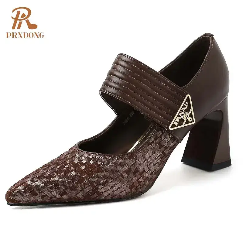 A brown high heel shoe featuring a woven design and a midfoot strap. Brown high heel shoe with a woven texture and a wide strap across the midfoot.